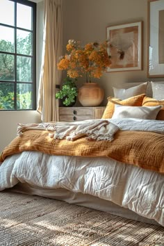 a bedroom with a bed, dresser and large window in it's center area