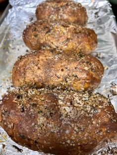 three loaves of bread sitting on top of aluminum foil