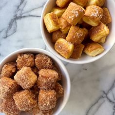 two bowls filled with pastries on top of a marble counter