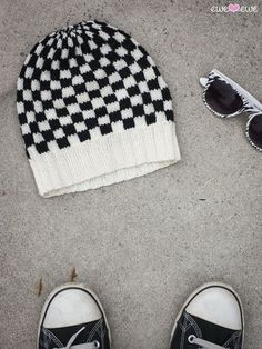 a hat, sunglasses and pair of shoes on the ground