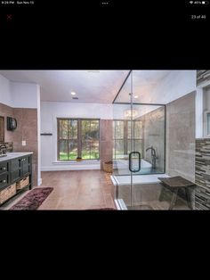 a large bathroom with a walk in shower next to a sink and mirror on the wall