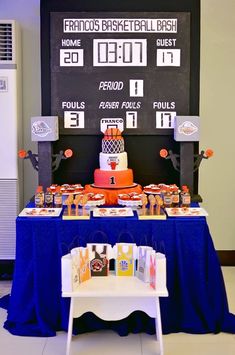 a basketball themed birthday party with cake and snacks on a table in front of a chalkboard