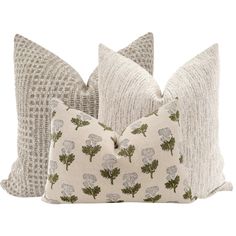 two pillows with flowers on them sitting next to each other