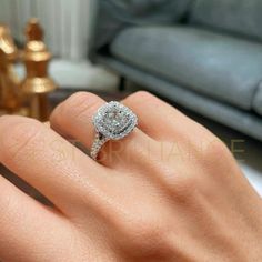 a woman's hand with a diamond ring on it