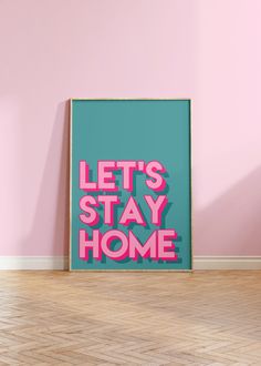 a pink and blue poster with the words lets stay home on it in front of a pink wall