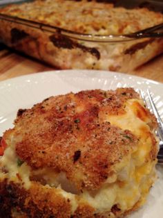 a white plate topped with food next to a casserole dish