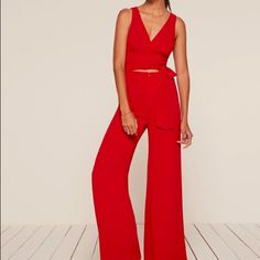 Jumpsuits Are Great Because They're A Top And Pants All In One - Less Work For You. This Is A Wrap Front Jumpsuit With A Slightly Cropped Top And A Center Front Zipper At The Waist. Chic Red V-neck Sets, Red Chic V-neck Sets, Red V-neck Chic Sets, Chic Red Sets For Night Out, Chic Red High-waisted Jumpsuits And Rompers, Chic Red High Waist Jumpsuits And Rompers, Red Pants For Summer Evening Events, Red Pants For Summer Evening, Red Wide-leg Pantsuit For Party