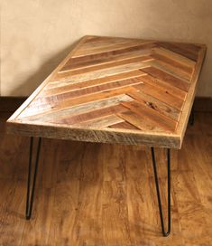 a wooden table sitting on top of a hard wood floor