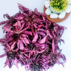 purple flowers and eggs on a white surface