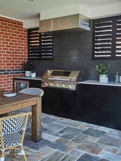 an outdoor kitchen with black and white tile flooring