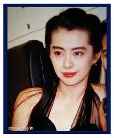 an old photo of a woman with long black hair and red lipstick on her face