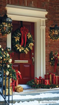 a red door decorated with christmas wreaths and presents