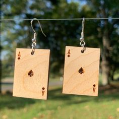 Ace Card Earrings Laser Engraved and Assembled by us in the foothills of North Carolina. Made with 925 Sterling Silver Hypo Allergenic Ear Hooks and Birch Wood. 1.25 " (inches) Tall 1/8" Thick Thanks for viewing :) Ace Card, Ace Of Spades, Ear Hook, Wooden Earrings, Laser Engraving, Playing Cards, Jewelry Earrings Dangle, Dangle Earrings, 925 Sterling Silver