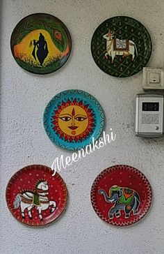 several colorful plates are hanging on the wall