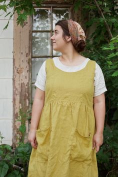 Made with 100% midweight linen.  This dress is both unique and gorgeous, with its rounded front neckline, and connecting strap on the back, functional wooden buttons on the back, full gathered straight skirt, and front rectangle pockets.  Standard is a mid calf length.  Picture yourself picking apples, walking through farmers markets, or even picking out your Christmas tree in this dress?!   Dress it up or down, with leggings and cozy sweaters for winter.  Choose from the US letter sizes, or the Custom option, and then send me your measurements for a customized fit.. Plus any other customizations you'd like for your order, please leave them in the  personalization section when you checkout!  I'm happy to personalize it for you! Womens Linen Dress, Picking Apples, Dresses Autumn, Linen Dress Women, Farmers Markets, Pinafore Dress, Wooden Buttons, Dress Midi, Straight Skirt