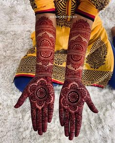 the hands and feet of a woman with henna tattoos