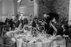 a group of people sitting around a table with plates and glasses in front of them