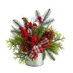 a christmas arrangement with pine cones and berries