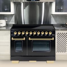 a black stove top oven sitting inside of a kitchen