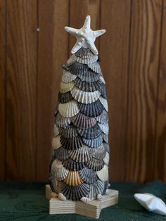 a small christmas tree made out of seashells