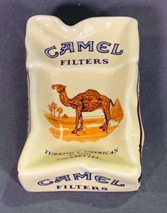 a ceramic camel canister with the words camel filters on it's front and side