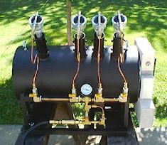 three propane tanks sitting on top of each other in front of a green lawn