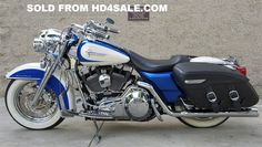 a blue and white motorcycle parked in front of a building with the words sold from hdasale com