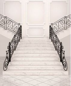 an empty staircase with wrought iron railing and handrails in front of a white wall