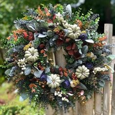 a wreath on the side of a wooden fence