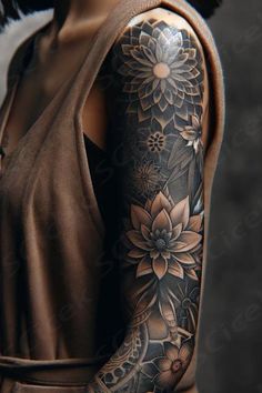 a woman's arm with flowers and leaves on the back of her body,