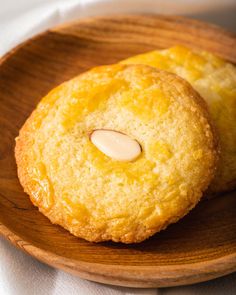 two cookies on a wooden plate with a white cloth