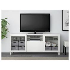 a flat screen tv sitting on top of a white entertainment center