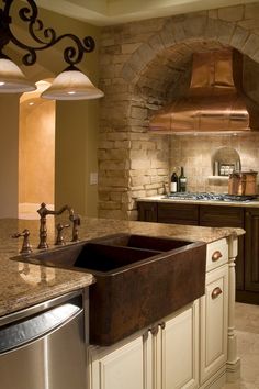 a kitchen with an oven, sink and stove in the middle of it's counter space