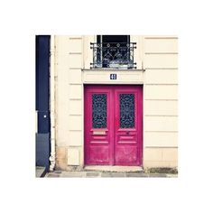 two red doors are in front of a building