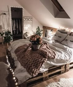 a bed made out of wooden pallets in a loft