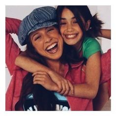 two girls are hugging each other and smiling