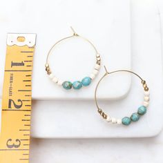 Pretty hoop earrings with turquoise and gold colors. These boho hoop earrings are colorful and pretty, and with popular turquoise, off white and golden brass beads will compliment most outfits. Medium sized hoop diameter is about an inch and a half. See final images for color choice options available in shop at in the hoop earrings section: www.etsy.com/shop/heatherberry Your new earrings will ship quickly in a little gift box. Find more awesome designs here: www.etsy.com/shop/heatherberry http: Turquoise Hoop Beaded Earrings For Jewelry Making, Turquoise Round Bead Earrings For Everyday, Turquoise Hoop Jewelry Wire Wrapped, Turquoise Hoop Earrings With Round Beads, Everyday Turquoise Round Bead Earrings, Everyday Turquoise Beaded Earrings, Turquoise Nickel-free Small Hoop Beaded Earrings, Turquoise Beaded Earrings With Small Hoop, Small Hoop Turquoise Earrings For Everyday