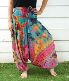 "💥One Size Fits Most Comfortable Low Cut Drop Crotch Tie Dye Harem Pants, Hippie Pants, Tie Dye Baggy Pants, Festival Harem Pants, Festival Clothing, Tye Dye Genie Pants, Tie Dye Comfy Pants 👉Fabric: Soft and Breathable Rayon 👉Smocked Elasticated Waist: 26\" up to 54\" 👉Hips up to: 60\" 👉Total Length: 39\" (Top to Bottom) 👉 Around elastic ankle 10\" 👉 Tie Dye Method 👉 One Size Fits M-XL or US 2-20 👉Extremely Comfortable 👉Boho/Hippie Theme, Beach Wear/Festival Going Pants Note: Due to t Hippie Relaxed Fit Harem Pants For Summer, Summer Hippie Relaxed Fit Harem Pants, Relaxed Fit Harem Pants For Summer Festivals, Casual Pink Harem Pants For Festival, Hippie Baggy Bottoms For Summer, Pink Casual Harem Pants For Festival, Summer Multicolor Relaxed Fit Harem Pants, Multicolor Harem Bottoms For Summer, Summer Hippie Harem Pants With Loose Fit