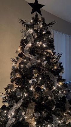 a black and silver christmas tree with lights