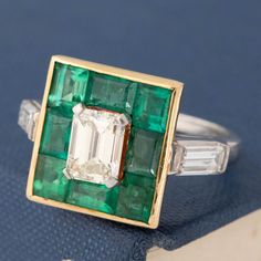 Absolutely special ring! we just fell in love with this ring instantly - from the war, buttery emerald cut center to the deep green emerald surround. Sitting low on the finger, the ring is all charm and beauty - and what a beautiful and one of a kind engagement ring she would make! Platinum & 18kt yellow gold Size 6 & resizable 1.10ct Center emerald diamonds is estimated to be N/O color & VVS clarity .68ctw Baguettes are estimated to be G/H colors & VVS/VS1 clarities Emeralds are estimated to be Luxury Square-cut Emerald Ring, Luxury Square-cut Emerald Ring With Diamonds, Exquisite Emerald-cut Emerald Ring, Vintage Platinum Emerald-cut Emerald Ring, Luxury Vintage Emerald Collectible Ring, Modern Mens Rings, Art Jewelry Earrings, All Band, Piece Sign