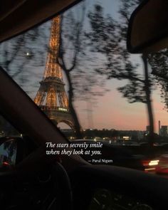 the eiffel tower seen from inside a car at night, with text overlaying it