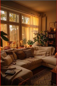 a living room filled with lots of furniture and large windows covered in sun shining through the curtains