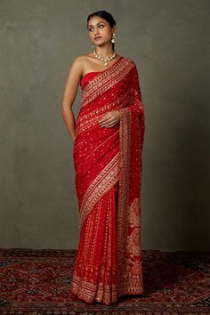 Red silk saree with all-over aari embroidery in a floral pattern. Comes with unstitched blouse fabric. Components:2 Pattern:Embroidery Type of Work:Aari Fabric:Saree: Silk and Blouse Fabric: Silk and Viscose Color:Red Other Details: Saree Length: 5.5 Mtr. Approx Weight: 450 gms Note: The stitched blouse worn by the model is not for sale Occasion:Bride - Aza Fashions Red Saree Wedding, Red Sari, Bridal Sari, Saree And Blouse, Simple Saree Designs, Indian Bridal Photos, Traditional Blouse Designs, Saree Designs Party Wear