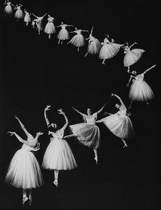 several ballerinas in white tutu skirts are dancing with their arms stretched out