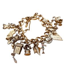 Vintage Monet Bracelet, Gold Tone, With Signature Tag With 11 Charms, Several Are Articulated/Have Moving Parts Clasp Works Well, There Is An Extra Chain To Attach For Security Includes The Following Charms - California State Shape Charm Monet Mouse / Rat Charm, He's Wearing A Vest And A Bowtie And Has Rhinestone Eyes Monet Poodle With A Crown, This One Has Wear To The To The Plating And His Lower Jaw Is Gone, Sorry Monet Cuckoo Clock Charm, Looks Like Parts May Move, But I'm Not Sure How? Monet Rhinestone Eyes, Vintage Charm Bracelet, Mouse Rat, Monet Jewelry, Vintage Monet, Gold Charm Bracelet, Wishing Well, California State, Red Stone