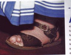 a person's feet with sandals on top of them