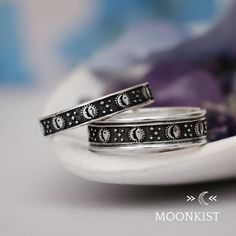 This Sterling Silver Eclipse Wedding Band Set is engraved with repeating sun and moon designs. The Wide band has been flanked by two rails of round Sterling Silver wire that both protect and enhance the stylized pattern. The inside of these bands have been smoothed for a comfortable fit, and is gently curved for comfortable wear. Materials - Sterling silver .925 Pattern Wire; Sterling Silver .925 Round Wire Dimensions - Narrow band width - 3 mm (about .10 inches); Wide band width - 6 mm (about . Eclipse Wedding, Moon And Sun Ring, Moon Designs, Silk Bracelet, Promise Rings For Couples, Curved Wedding Band, Bridal Ring Sets, Wedding Band Sets, Engagement Rings For Men