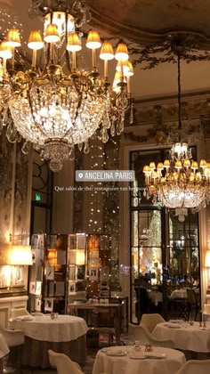 an elegant dining room with chandeliers and white tablecloths on the tables