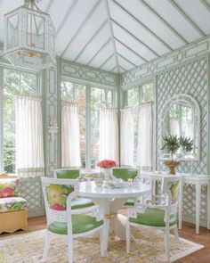 a dining room with green chairs and a white table