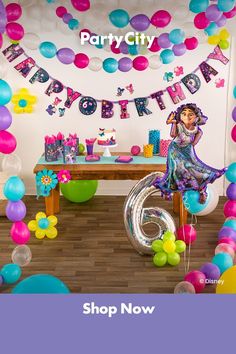 a birthday party with balloons and streamers on the wall, including an image of a woman sitting at a table